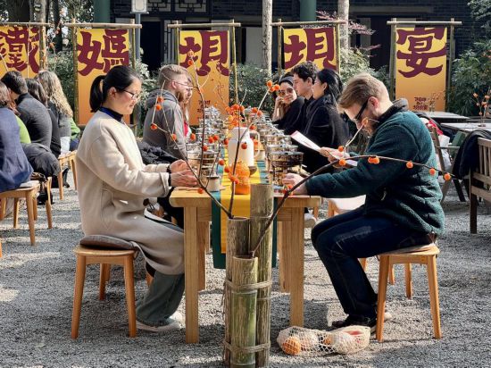 哥倫比亞大學青年學生代表團與蒲江縣鐵牛村村民一起交流、品嘗當地的小火鍋。