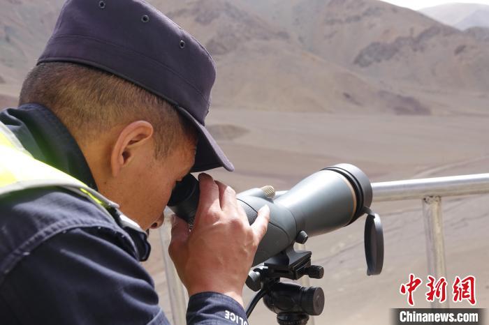 索朗曲扎用望遠(yuǎn)鏡查看邊境情況。　冉文娟 攝